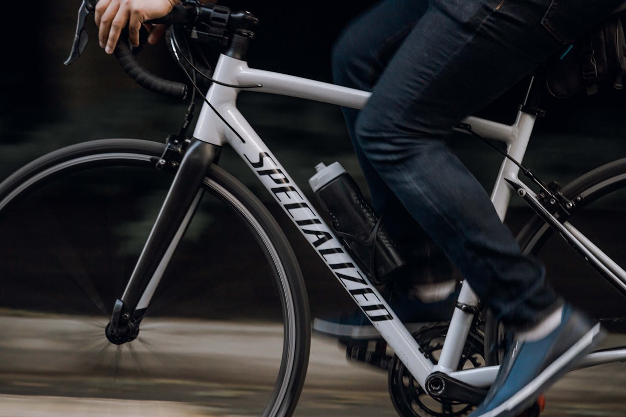 Dynamic shot of an adult riding a bicycle, showcasing movement and urban lifestyle.