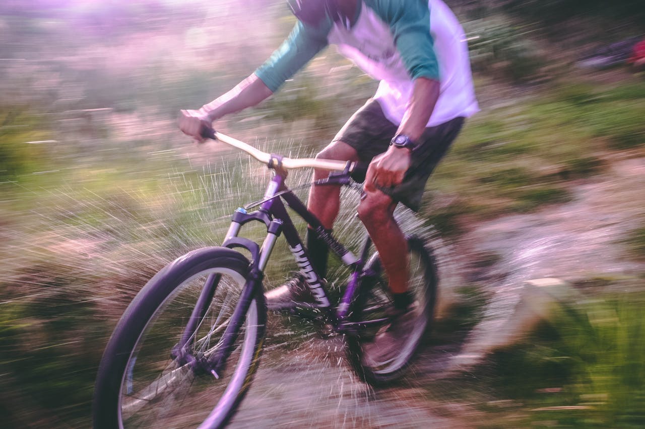 Thrilling mountain biking action captured in motion with blurred background for dynamic effect.